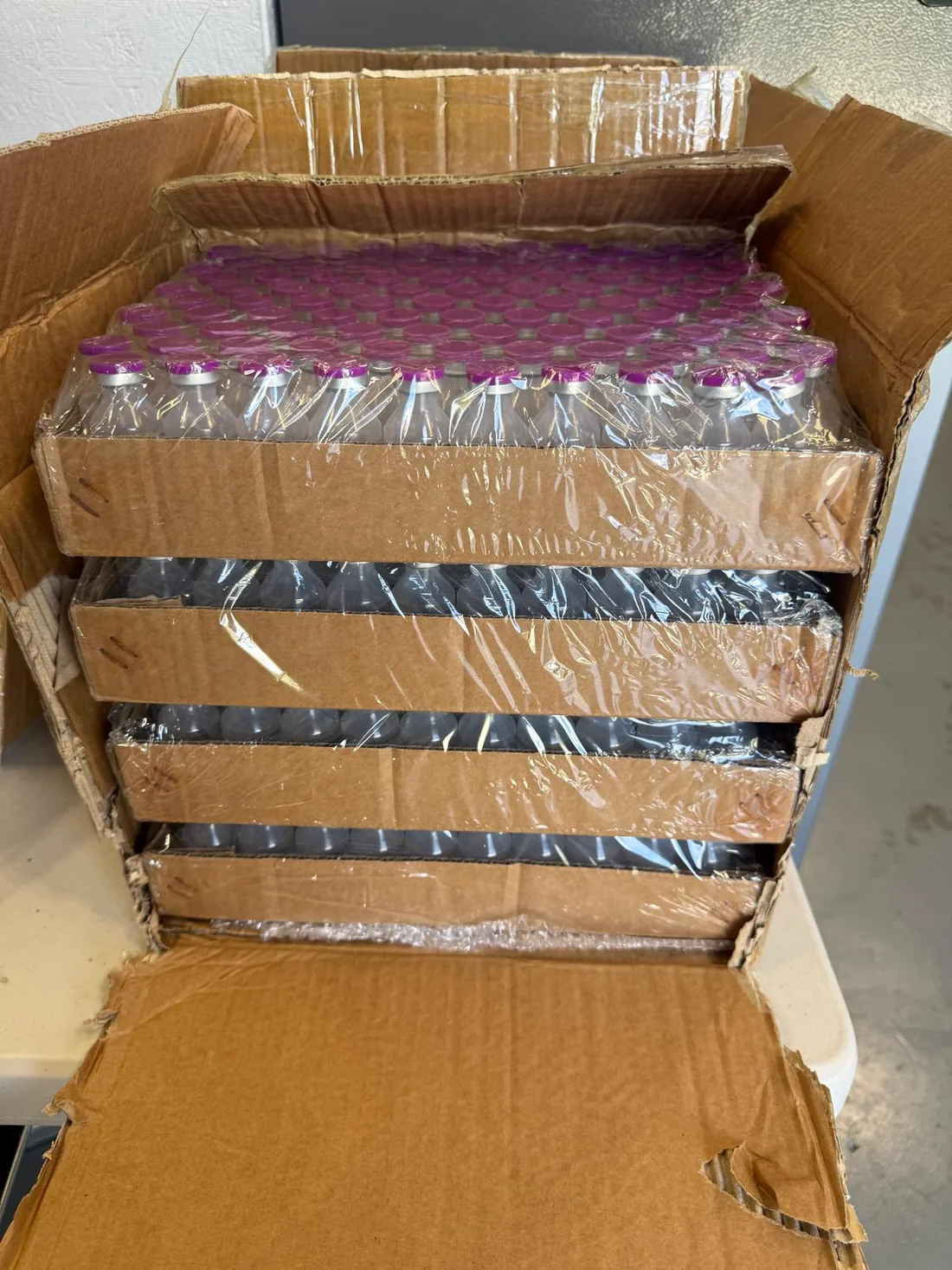 Bulk shipment of 30 mL vials in shrink-wrapped trays in a carton