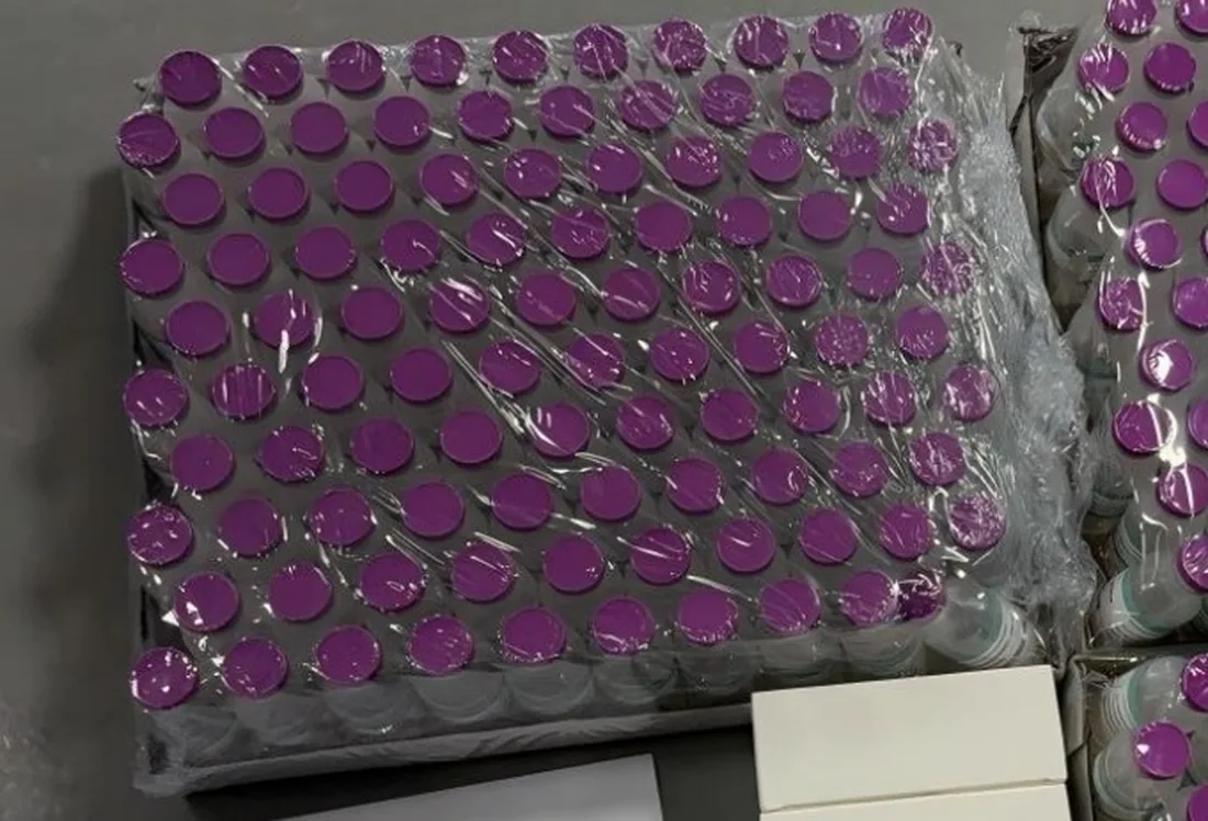 Shrink-wrapped tray of 30 mL bacteriostatic water vials with purple caps